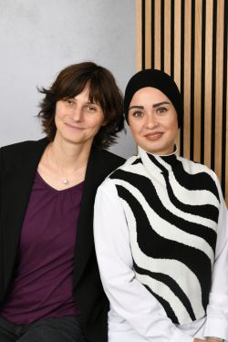 Unsere Schulsozialarbeiterinnen vor einer Akustikwand.